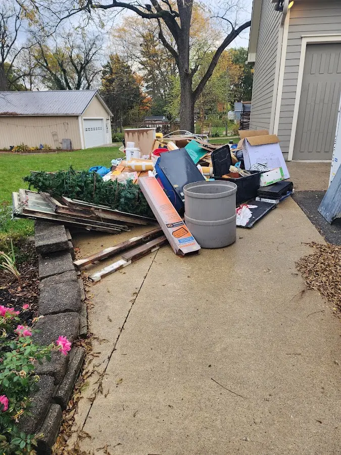 Dumpster being loaded with debris for 3 Yard Dumpster Rental in Parma Heights